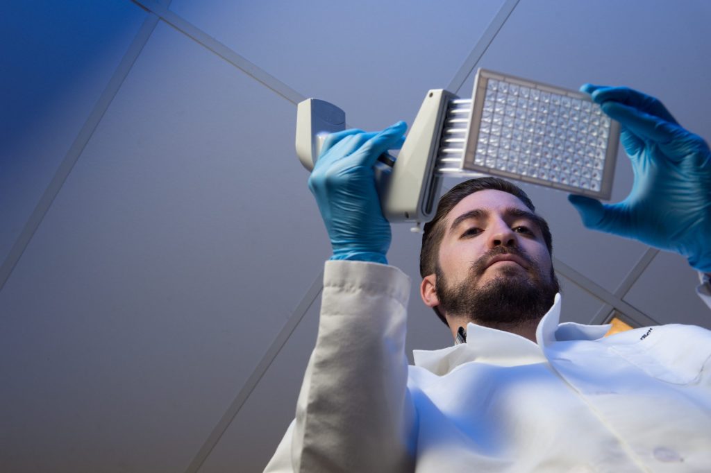 Student using multichannel pipette.