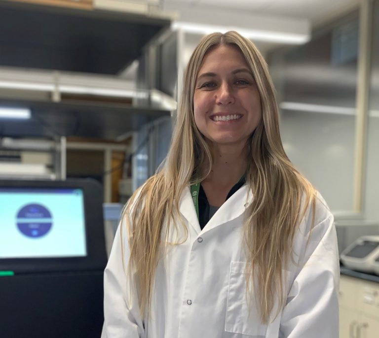 CSU student Katie Miller poses in a chemical and biological engineering lab in the Scott Bioengineering Building.