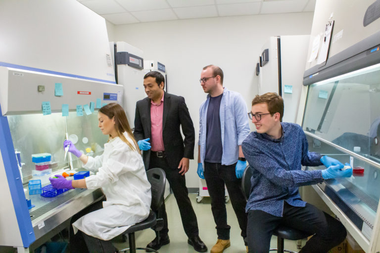 Students work in a lab with Soham Ghosh