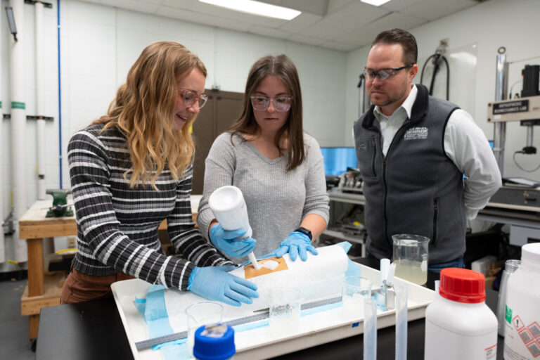 Mechanical engineering graduate students Amelia Stoner (middle) and Jacqueline Linn (left) deploy the medical foam into a model wound. (CSU photo)