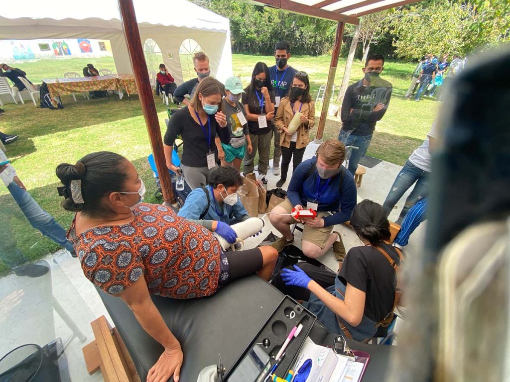 CSU students participating in the Summer 2025 trip to Quito, Ecuador, affix a prosthetic limb to a patient.