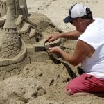 man building sandcastle