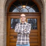 Picture of Mohammad Teymouri in front of wooden doors