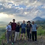 Students pose in front of mountain valley in El Salvador.