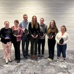 Students posed holding awards.
