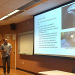 Student presenting research in a classroom.