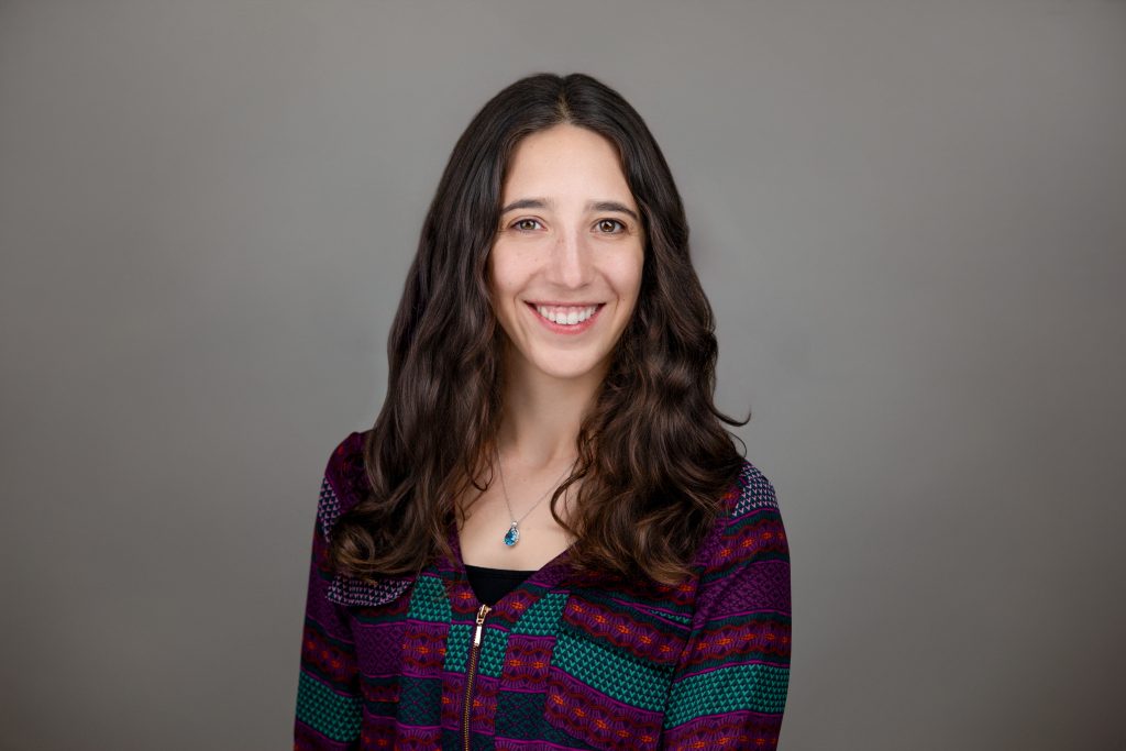 Portrait of woman in multicolor top.