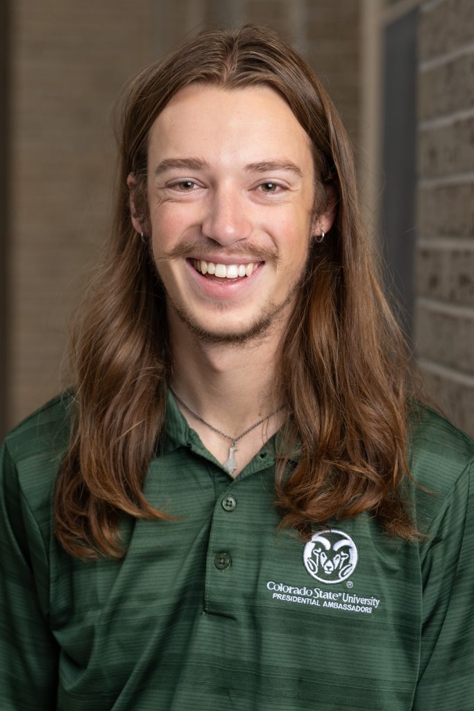Portrait of man in green shirt.