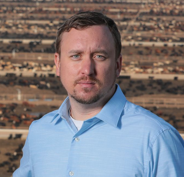 Portrait of man in blue shirt.
