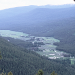 Aerial photo of winding river in mountain valley.