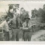 Black and white photo of men in discussion.