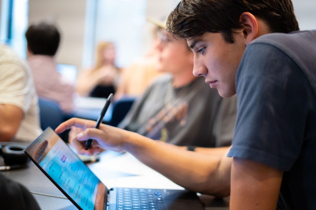 Student looking at laptop.