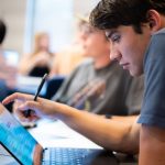 Student looking at laptop.