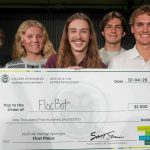 Group of students hold large check for $1,500 made out to "FlocBot".