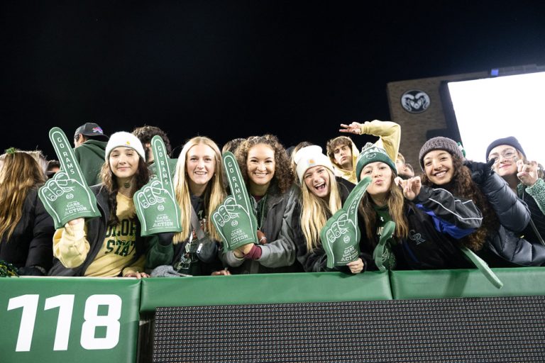 Students cheering at a football game.