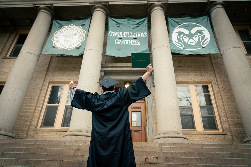 Student celebrating graduation at the oval