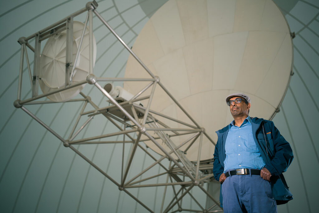 Prof. V Chandrasekar standing in front of large radar device