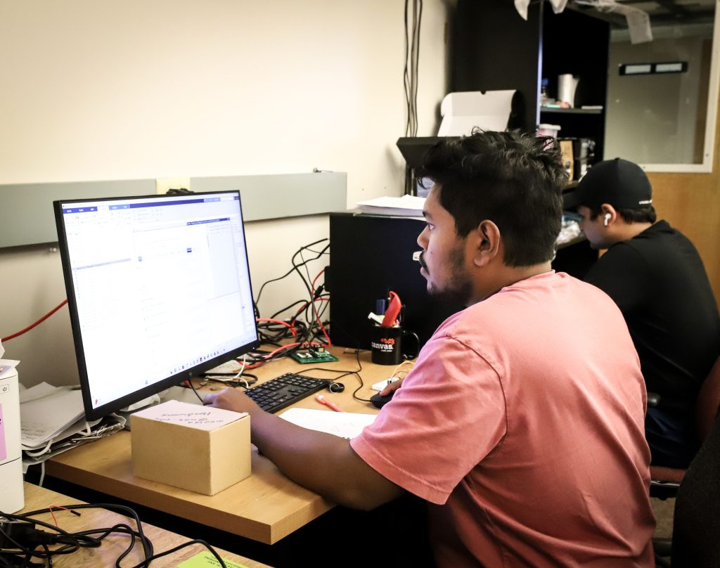 student looks at a computer monitor