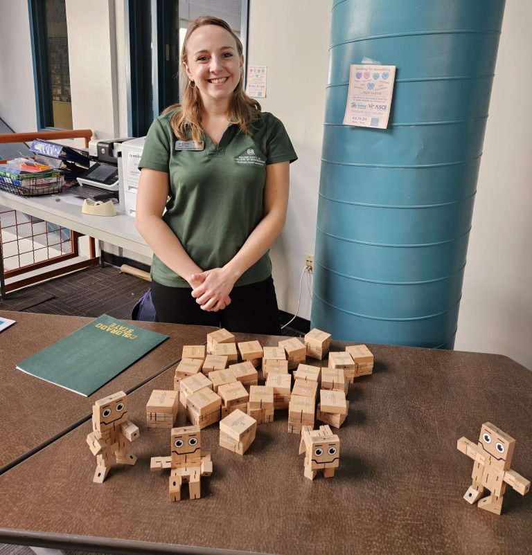 Woman stands in front of table display