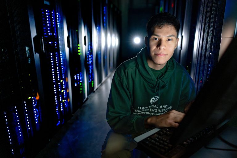 male student at computer in data center