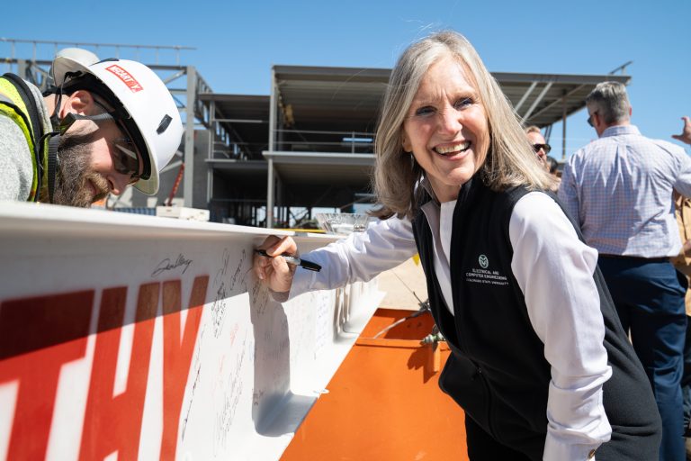Carmen Menoni signs building beam