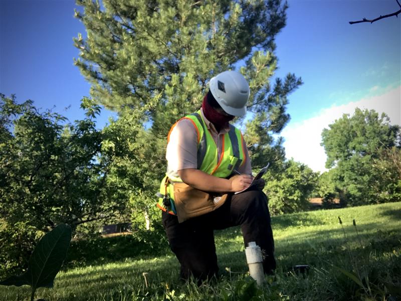 Dixie Poteet taking notes while preforming field work