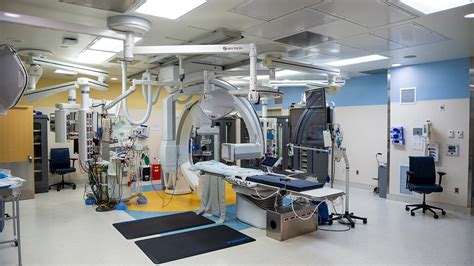 The operating room of the Children's Hospital Colorado's cardiac catheterization laboratory. An operating table is surrounded by an array of medical equipment.