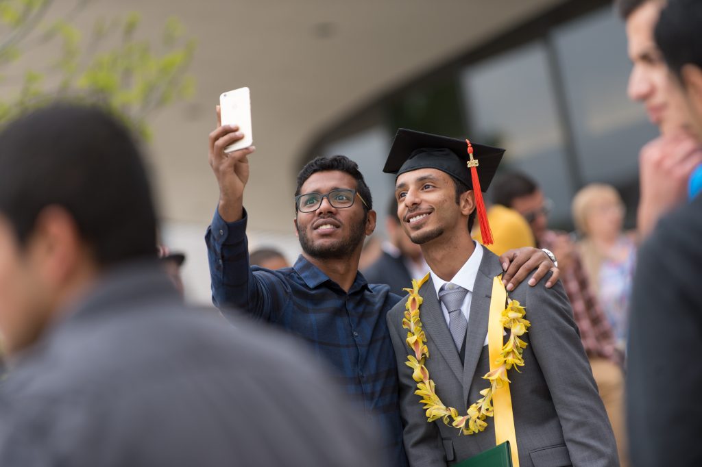 Two men pose for a selfy
