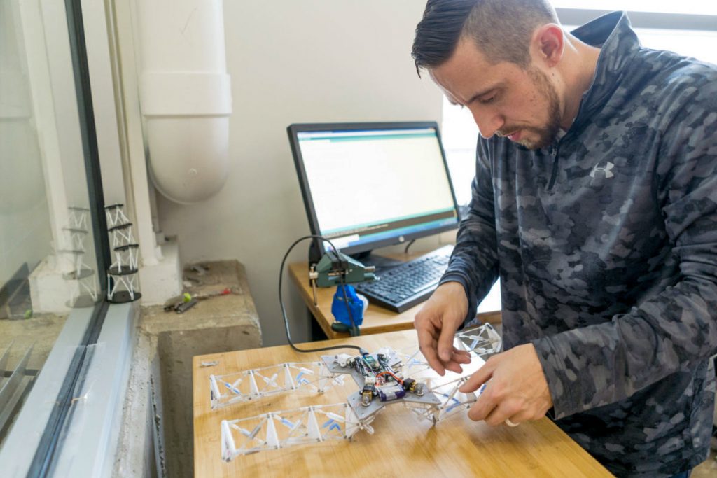 A man working on an adaptive robot