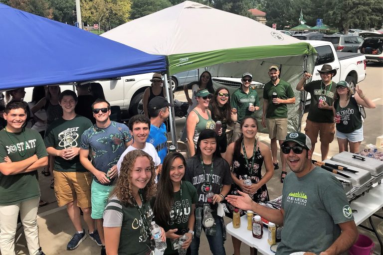 A group posing together at a tailgate party