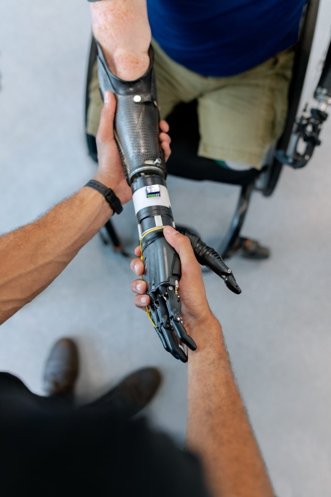 A robotic arm shakes hands