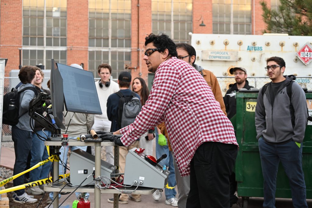 Student reading the data from a jet engine firing