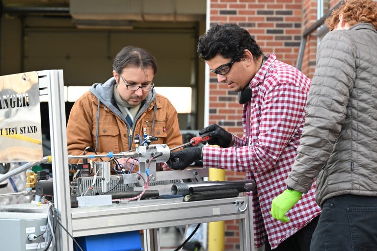 Student reading the data from a jet engine firing