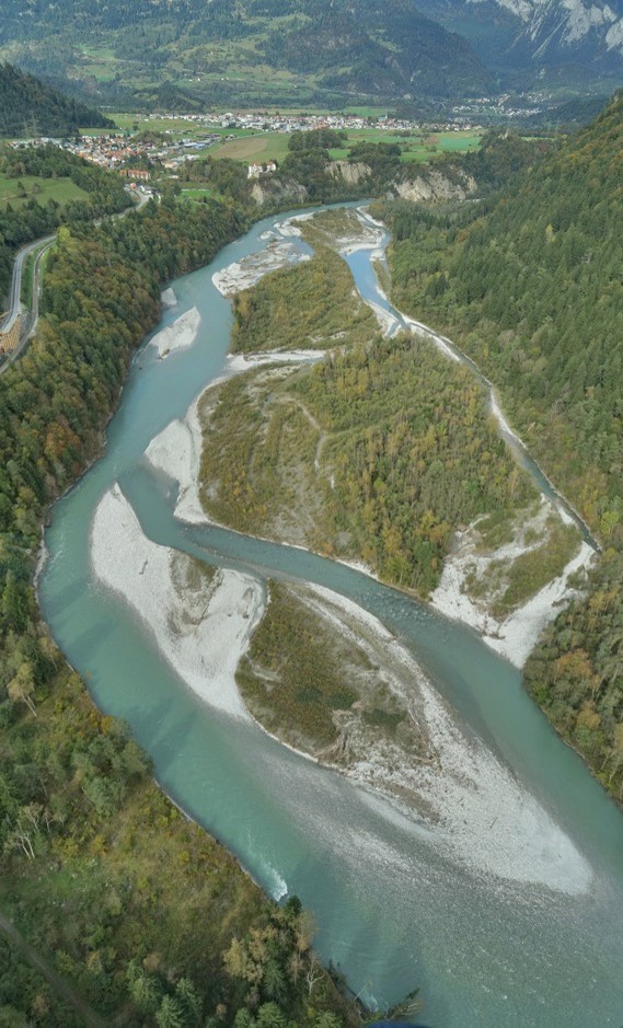 Aerial shot of river and green surroundings.