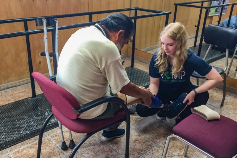 Colorado State University SBME student, Katie Brown, works with a patient to fit a prosthetic in a clinic in Quito, Ecuador in partnership with the Range of Motion Project (ROMP). Photo Credit: Ellen Brennan-Pierce