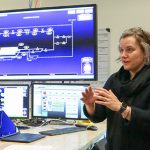 Jennifer Kurtz, systems engineering alumni, standing at the ECASS lab at NREL