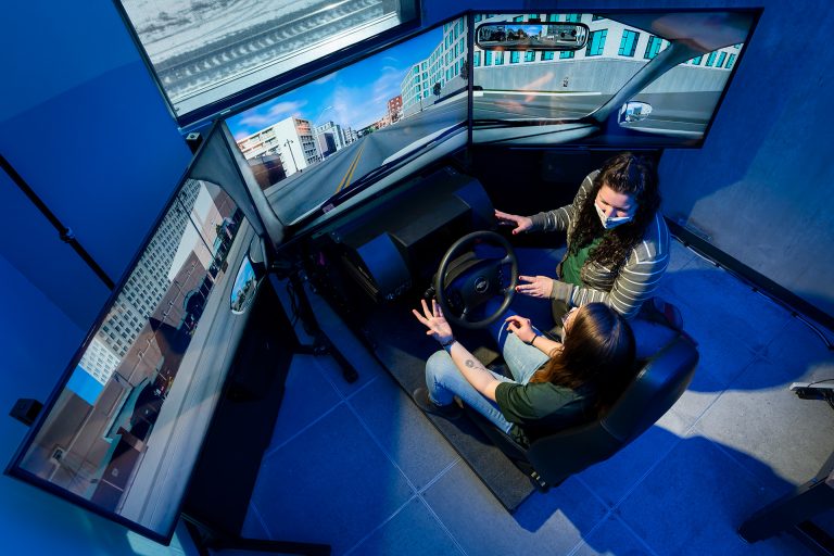 Erika Miller, Assistant Professor in the Systems Engineering department in the Walter Scott, Jr. College of Engineering works with test student on drive simulator, December 17, 2020.