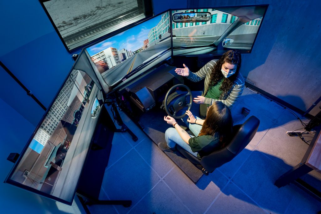 Erika Miller, Assistant Professor in the Systems Engineering department in the Walter Scott, Jr. College of Engineering works with test student on drive simulator, December 17, 2020.