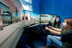 Erika Miller, Assistant Professor in the Systems Engineering department in the Walter Scott, Jr. College of Engineering works with test student on drive simulator, December 17, 2020.