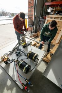 Jeremy Daily, Assistant/Associate Professor-Cyber Security in the department of Systems Engineering in the Walter Scott, Jr. College of Engineering works with graduate students in putting together test platforms for his research at Colorado State University's Powerhouse, December 17, 2020.