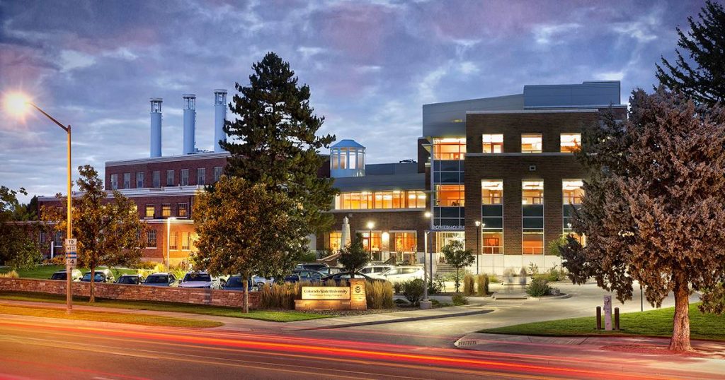 Photo of the outside of the Powerhouse Campus, a building with smoke stacks that were converted to wind turbines.