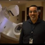 Edwin V. Standing near some medical imaging equipment
