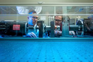 Jim Cale and a student look at lab equipment.