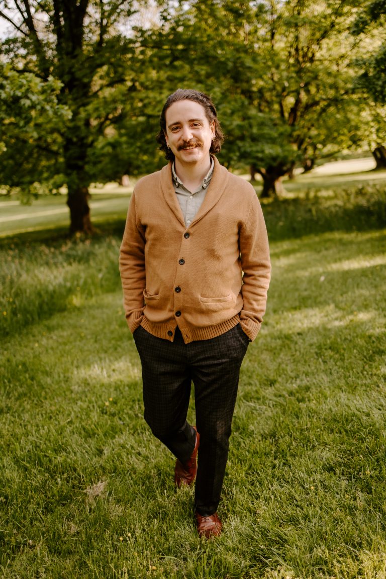 Vincent "Vinnie" Paglioni stands outside under leafy trees.