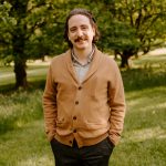 Vinnie has a mustache and brown coat.