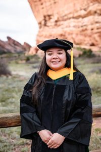 Professional image of a smiling woman in graduation regalia.