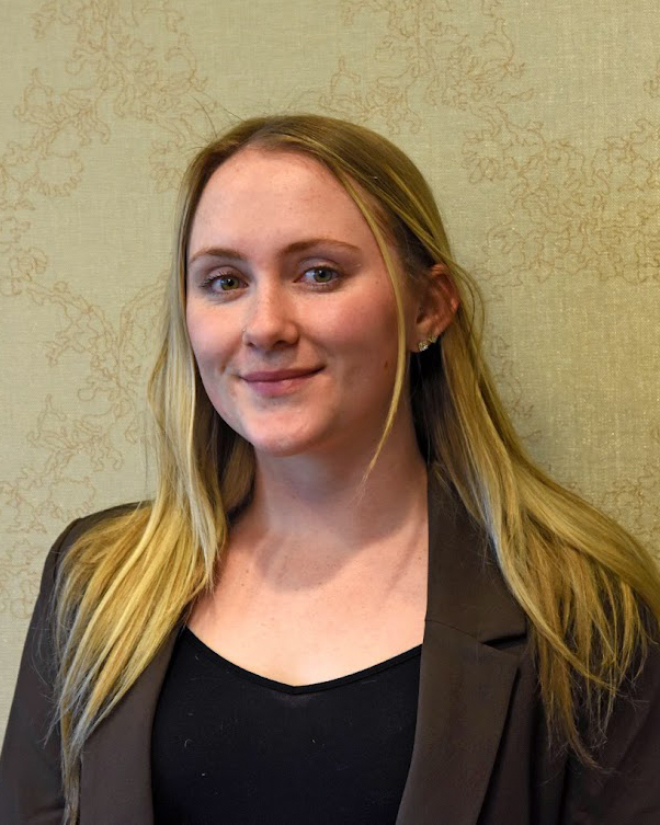 A woman smiling indoors.