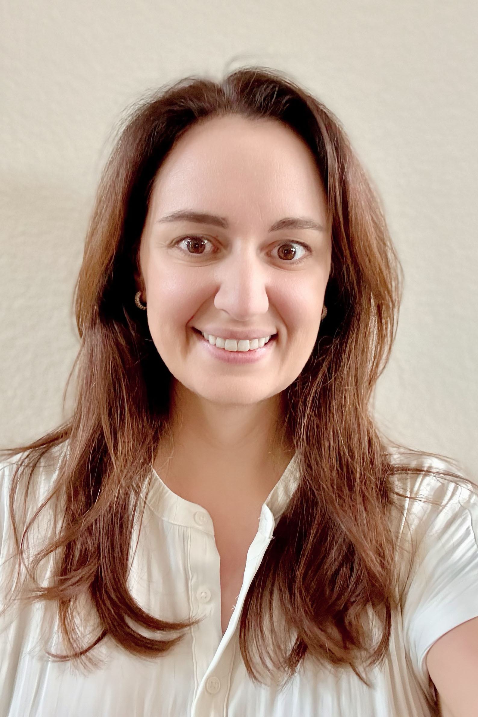 A woman wearing a formal blouse.