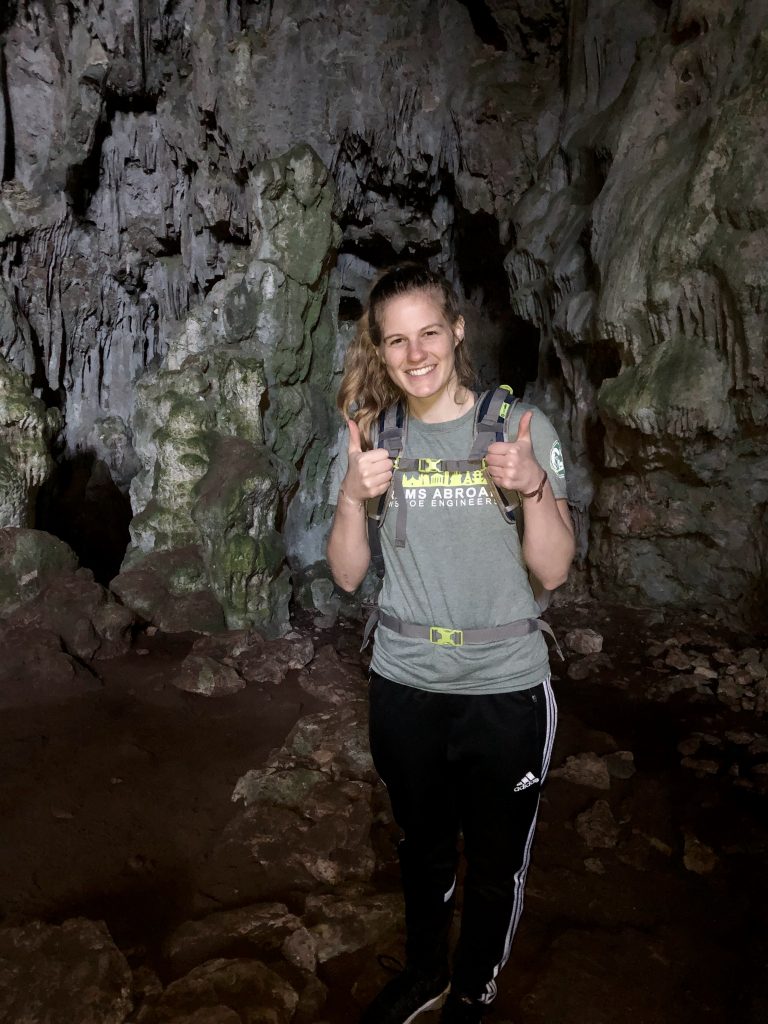 Student wearing "CSU Rams Abroad" shirt in a cave in Spain
