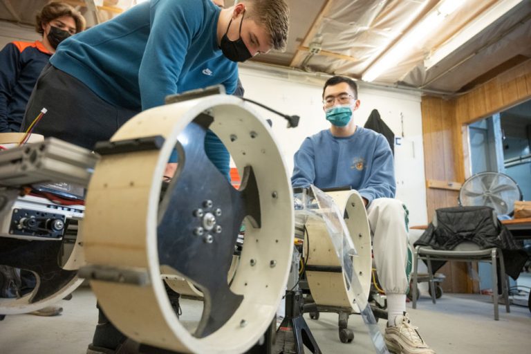 The Senior Design Team “NASA Robotic Mining Competition Team” consisting of Mechanical Engineering students Carissa Vos, Corbyn Berg, Hunter Pearson, Noah Kolda, Zelin Yang, Mike Irlbeck, Logan Litchfield and Electrical and Computer Engineering majors Dylan Clem and Ryan Busue, work on their chassis in a test pit. December 12, 2021